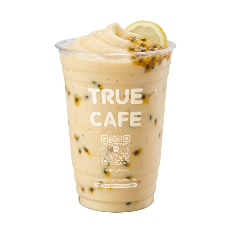 Ly Sinh Tố Chanh Dây True Cafe màu vàng kem, hạt chanh dây rải trong ly và lát chanh trên miệng